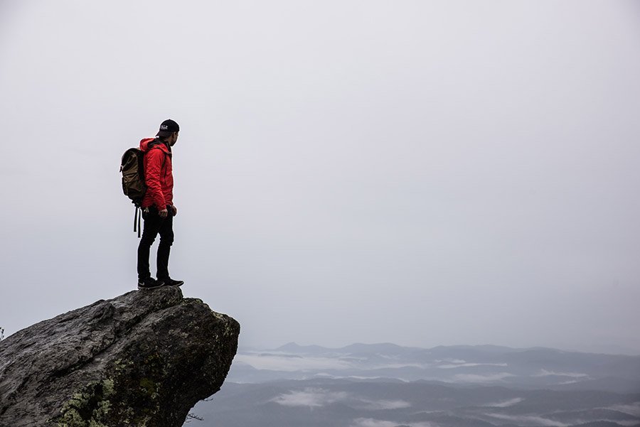 Hiker at top of mountqin