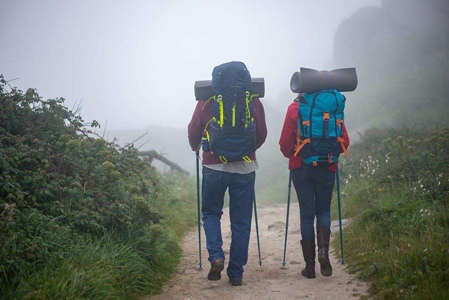 Couple hiking with trekking poles