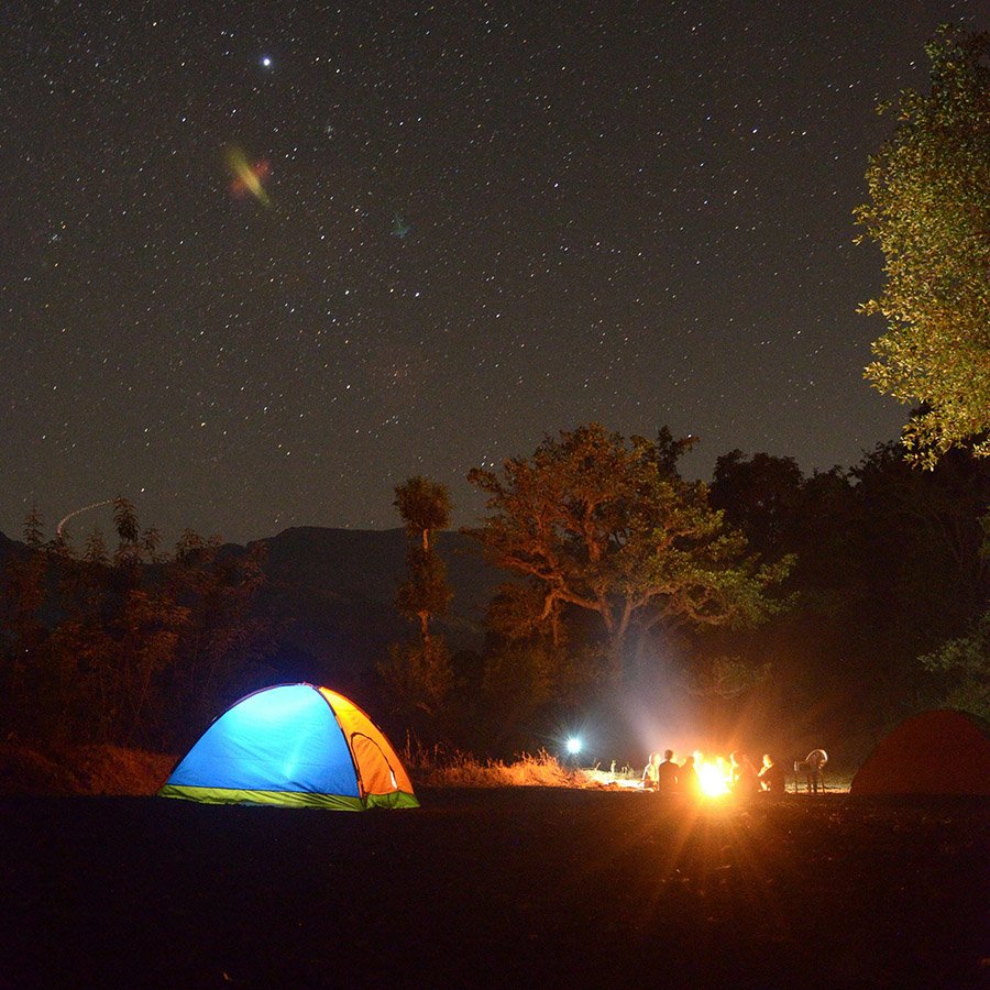 Camping with tent and campfire